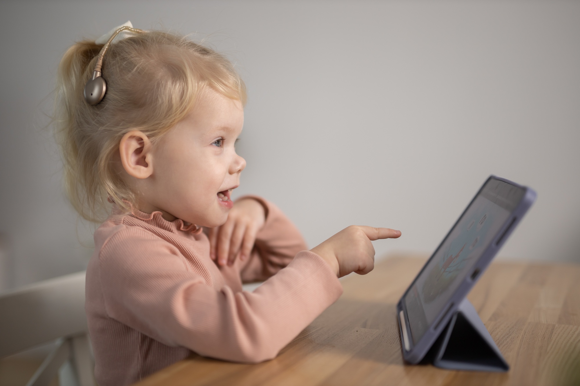 Cochlear implant system. Installation cochlear implant on child girl ear for restores hearing. Kid