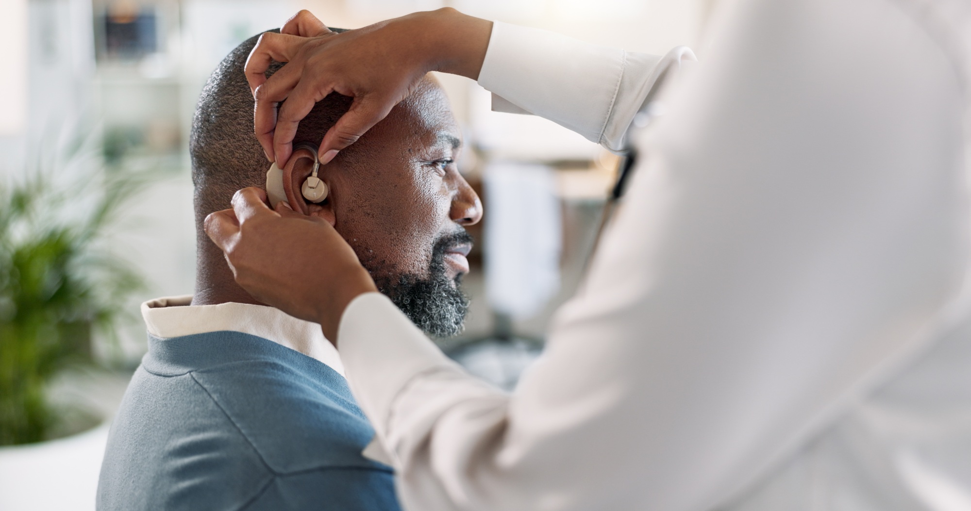 Man, ear and hearing aid with healthcare, medical support and placement with implant for sound and