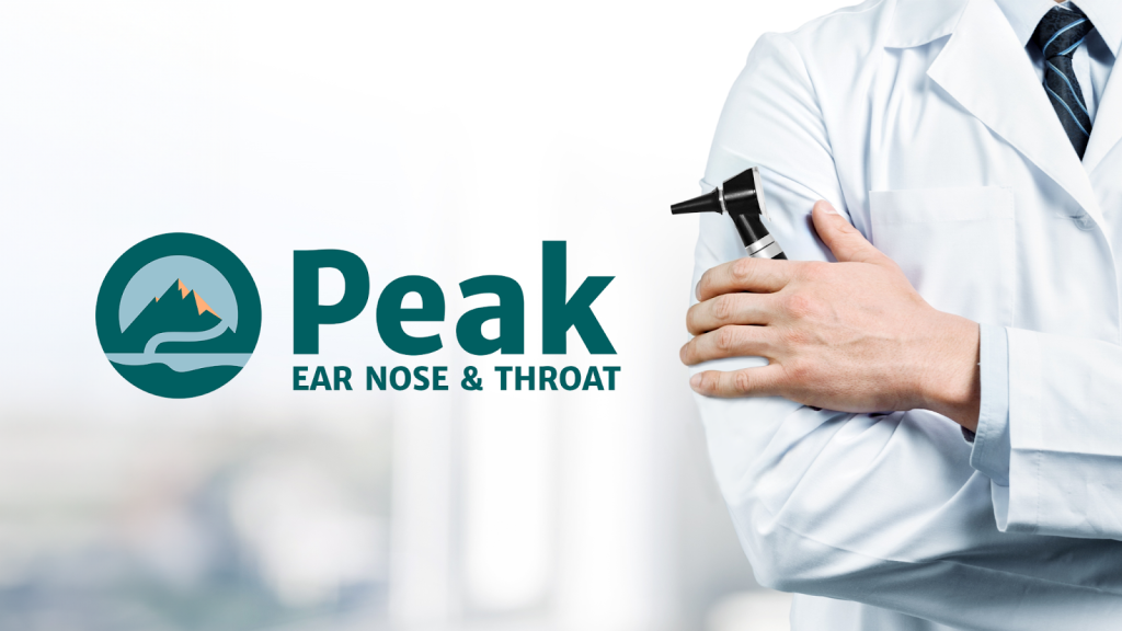 Image of a medical professional examining a patient's ear nose and throat in a clinical setting