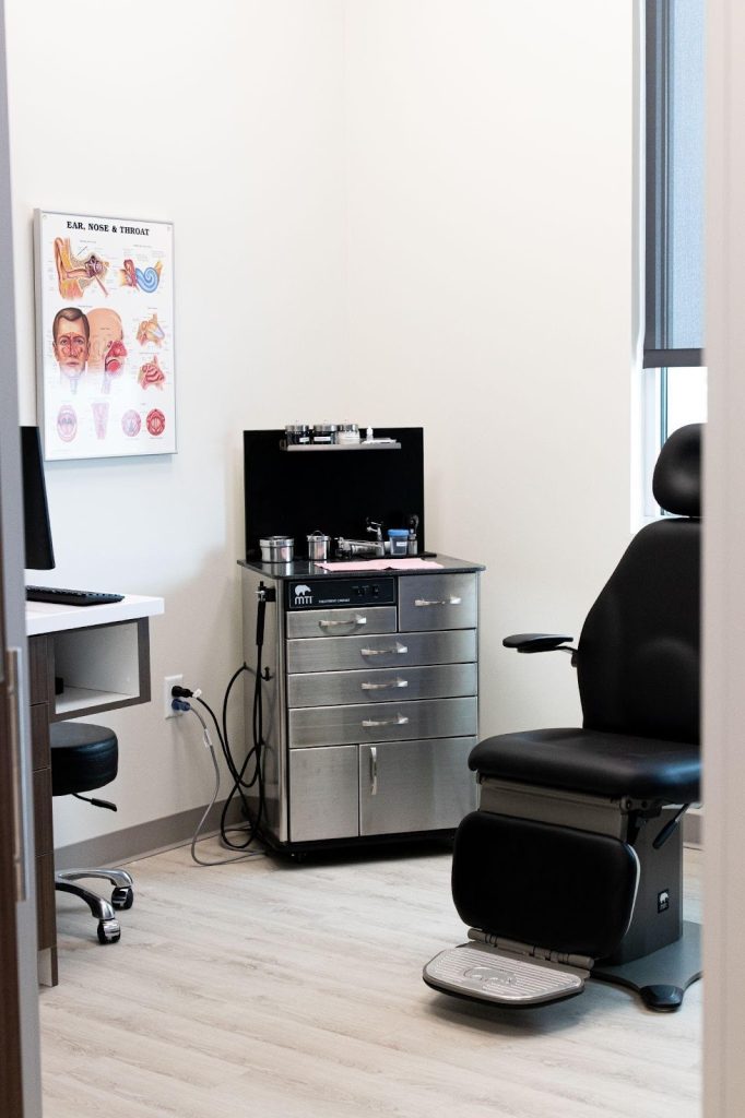 A dental office featuring a patient chair and a desk designed for dental examinations and treatments