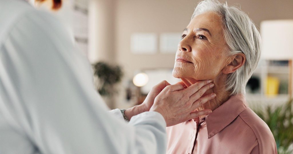 A woman receives a medical examination from a doctor in a clinical setting